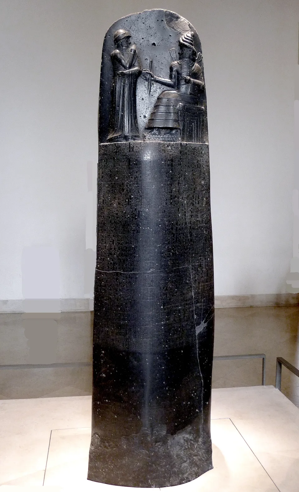 Stele of the Code of Hammurabi: Hammurabi before the sun god Shamash at the top, the laws in cuneiform below — Louvre