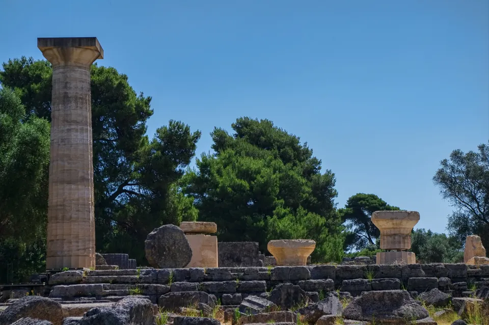 Ruins of the Temple of Zeus at Olympia — the west end, with fallen column drums scattered around