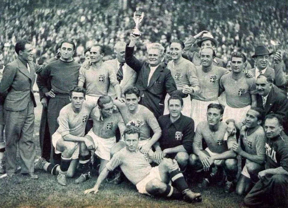 Italy’s coach Vittorio Pozzo raises the trophy after the final at Colombes, 19 June 1938
